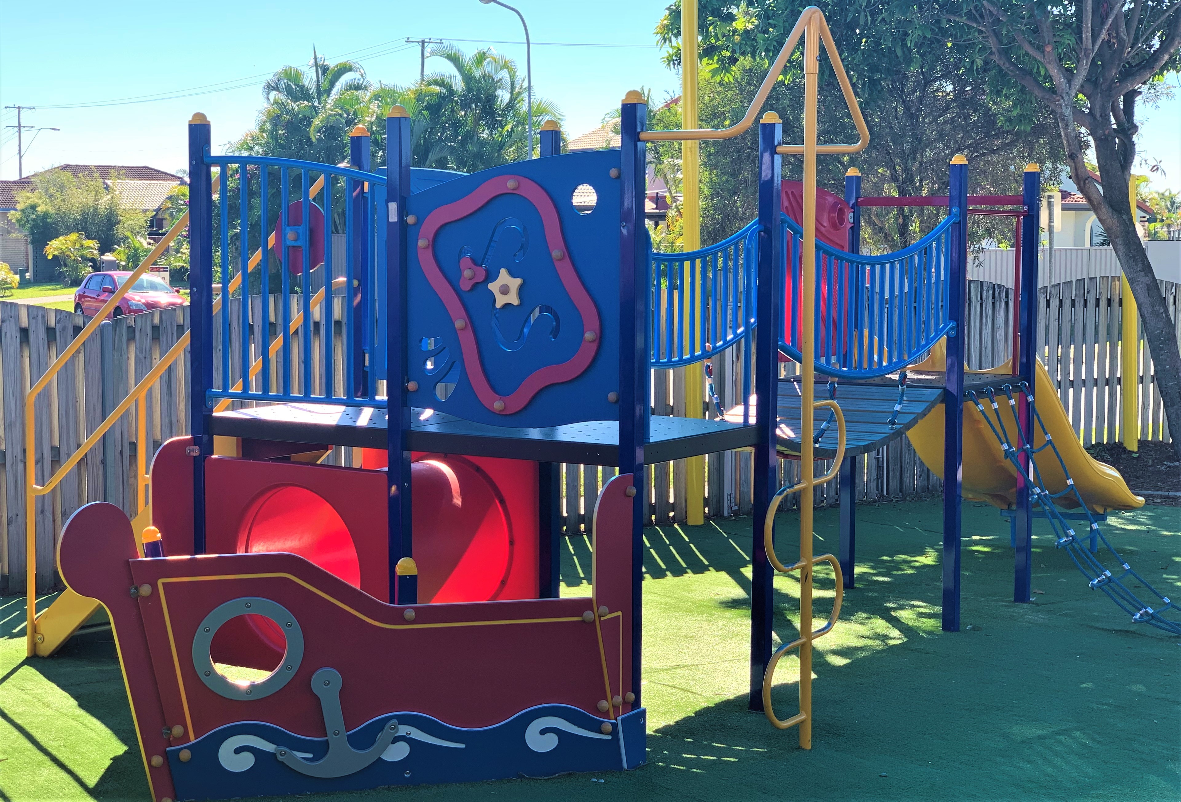 Colourful playground with climbing structures bridge and slide supporting active play coordination and physical development